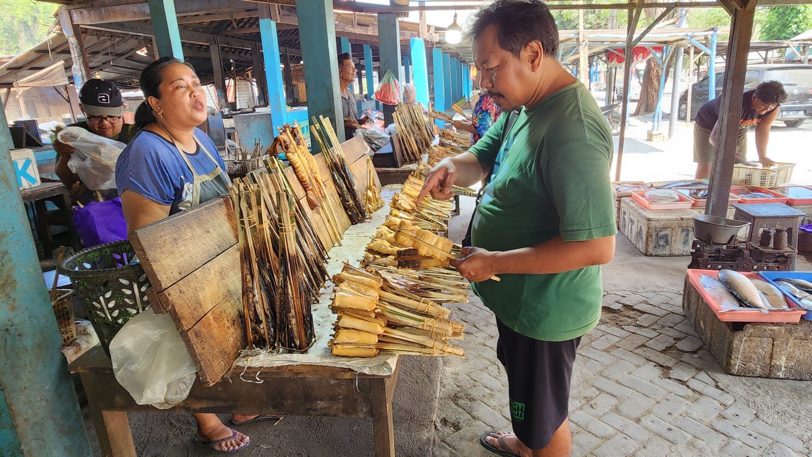 Pengunjung memilih dan membeli aneka hasil laut di kawasan Pantai Tambakrejo, Kabupaten Blitar, untuk dijadikan oleh-oleh maupun dinikmati langsung bersama keluarga.